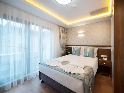 a bedroom with a bed and a large window at Lika Hotel - Superior Double or Twin Room in Istanbul