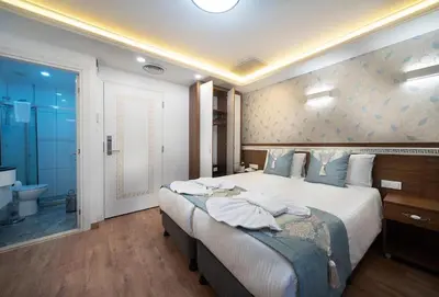 a bedroom with a large bed and a bathroom at Lika Hotel - Superior Double or Twin Room - Luxury in Istanbul Center in Istanbul