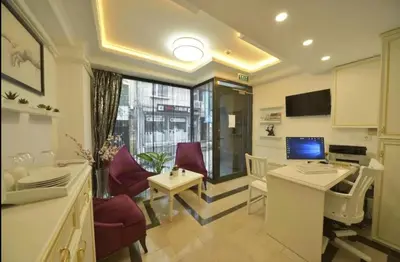 a living room with a table and chairs and a television at Lika Hotel - Superior Double or Twin Room - Luxury in Istanbul Center in Istanbul