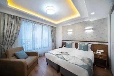 a hotel room with a bed and a chair at Lika Hotel - Superior Double or Twin Room - Luxury in Istanbul Center in Istanbul