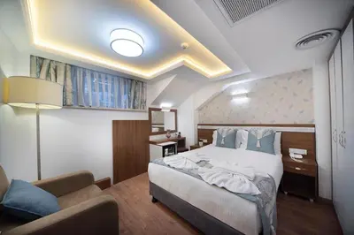 a bedroom with a bed and a couch in a room at Lika Hotel - Comfortable Double Room in Istanbul in Istanbul
