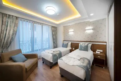 a hotel room with two beds and a couch at Lika Hotel - Superior Double or Twin Room - unforgettable holiday in Istanbul in Istanbul