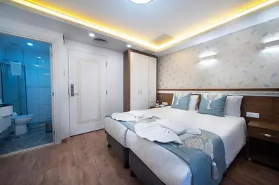 a bedroom with a large bed and a bathroom at Lika Hotel - Superior Double or Twin Room - unforgettable holiday in Istanbul in Istanbul
