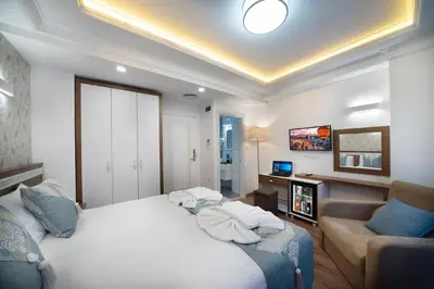a hotel room with a bed and a couch at Lika Hotel - Beautiful Standard Double or Twin Room in Center Istanbul in Istanbul