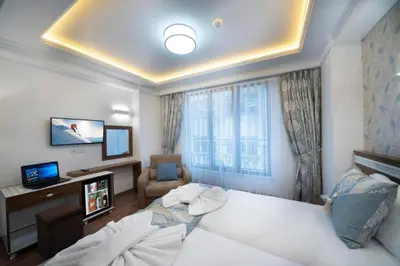 a hotel room with a bed and a tv and a room at Lika Hotel - Beautiful Standard Double or Twin Room in Center Istanbul in Istanbul