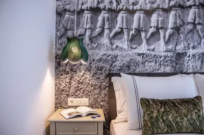 a bedroom with a bed and a table with a book and a lamp at 9 Doors Hotel in Istanbul