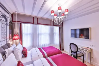 a bedroom with a white bed and a chandelier at 9 Doors Hotel in Istanbul