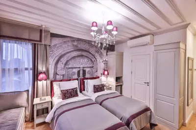 a bedroom with two beds and a chandelier at 9 Doors Hotel in Istanbul