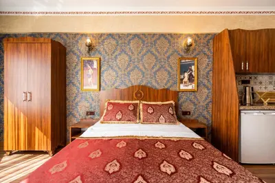 a bedroom with a large bed with a red blanket at The First Ottoman Dream in Istanbul