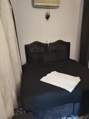 a bed in a room with a black bed with a pillow at Reydel Hotel in Istanbul