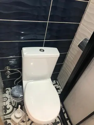 a white toilet in a bathroom with blue walls at Reydel Hotel in Istanbul