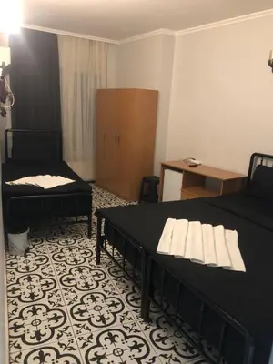 a room with a bed and a couch and a table at Reydel Hotel in Istanbul
