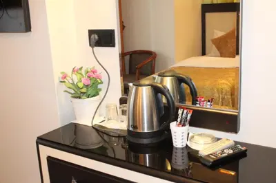 a bathroom vanity with a coffee maker and a mirror at Hotel Falcon in Istanbul