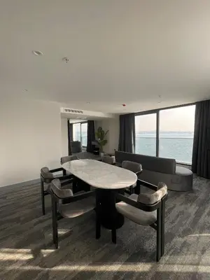 a living room with a table and chairs and a couch at Pera Bosphorus Hotel in Istanbul