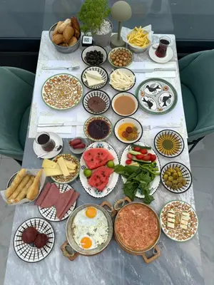 a table topped with lots of different types of food at Pera Bosphorus Hotel in Istanbul
