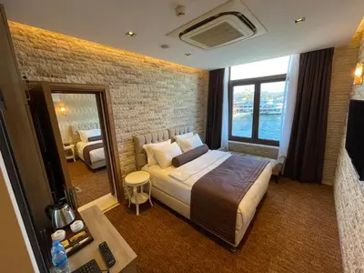 a hotel room with a bed and a mirror at Weingart Seaside Hotel in Istanbul