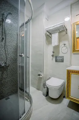 a bathroom with a toilet and a glass shower at Gülec Konak Hotel in Istanbul