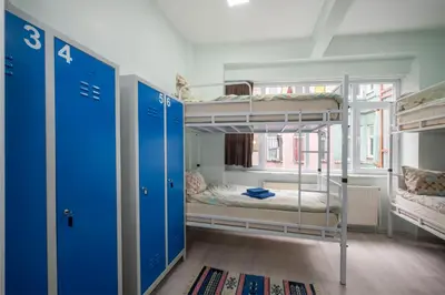 a room with two bunk beds and a window at XALİLA HOSTEL & CAFE, MEN's ROOM, BEST IN ISTANBUL , in Istanbul