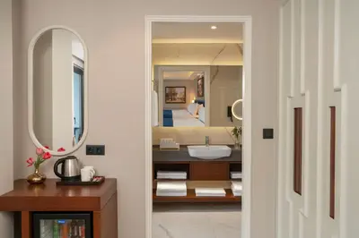 a bathroom with a bed and a sink and a mirror at Royan Hotel Hagia Sophia, a member of Radisson Individuals in Istanbul