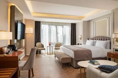a hotel room with a large bed and a desk at Royan Hotel Hagia Sophia, a member of Radisson Individuals in Istanbul