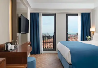 a hotel room with a bed and a balcony at Royan Hotel Hagia Sophia, a member of Radisson Individuals in Istanbul