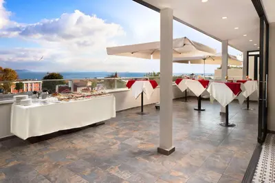 a restaurant with white tables and chairs on a balcony at Royan Hotel Hagia Sophia, a member of Radisson Individuals in Istanbul