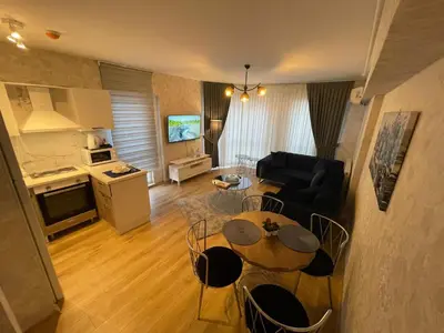 a kitchen and a living room with a table and chairs at King Suite SS0 in Istanbul