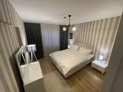 a bedroom with a white bed and two tables at King Suite SS0 in Istanbul