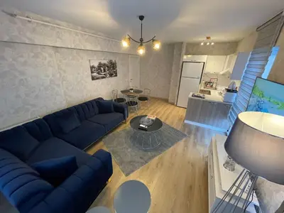 a living room with a blue couch and a table at King Suite SS0 in Istanbul