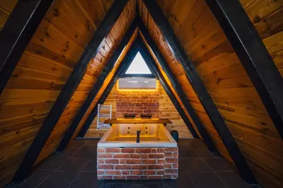 a bath tub in the middle of a attic at Tree Bungalov Maşukiye in Kartepe