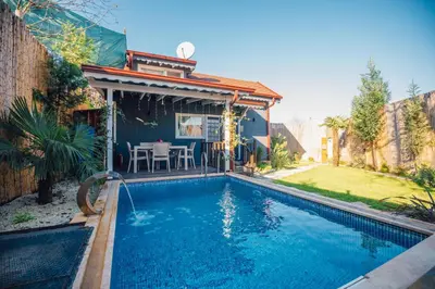 a swimming pool in the backyard of a house at Tree Bungalov Maşukiye in Kartepe