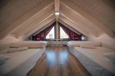a room with three beds in a room with a window at Tree Bungalov Maşukiye in Kartepe