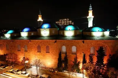 a large building with blue domes on top of it at ViP Apartments in Çekirge