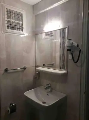 a bathroom with a sink and a mirror at ViP Apartments in Çekirge
