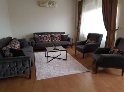 a living room with couches and a coffee table at ViP Apartments in Çekirge