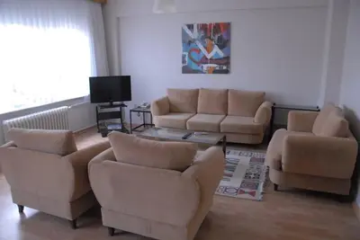 a living room with two couches and a tv at ViP Apartments in Çekirge
