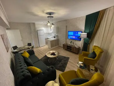 a living room with a couch and yellow chairs at King Suite SS4 in Istanbul