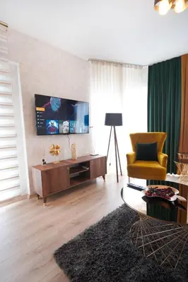 a living room with a tv and a couch and a chair at King Suite SS4 in Istanbul
