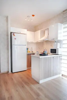 a kitchen with white cabinets and a white refrigerator at King Suite SS4 in Istanbul