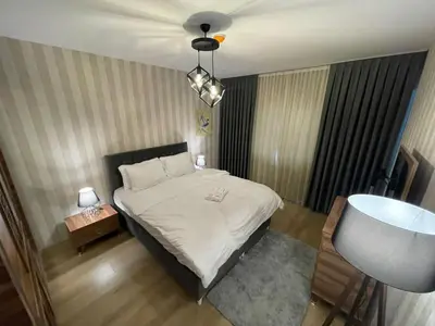 a small bedroom with a bed and a lamp at King Suite AE4 in Istanbul