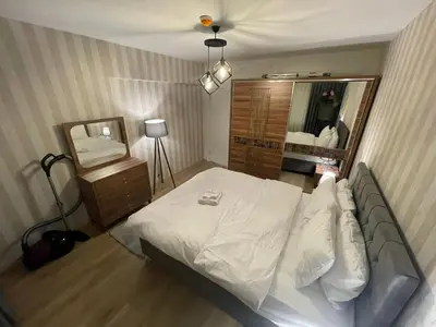 a bedroom with a white bed and a mirror at King Suite AE4 in Istanbul