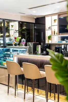 a restaurant with a counter and chairs in front of it at Aprilis Deluxe Hotel in Istanbul