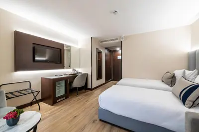 a hotel room with a bed and a desk at Aprilis Deluxe Hotel in Istanbul