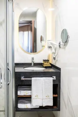 a bathroom with a sink and a mirror at Aprilis Deluxe Hotel in Istanbul