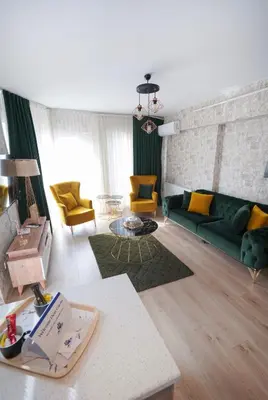 a living room with a green couch and yellow chairs at King Suite BH37 in Istanbul