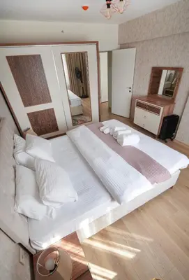 a large white bed in a room with a mirror at King Suite BH37 in Istanbul