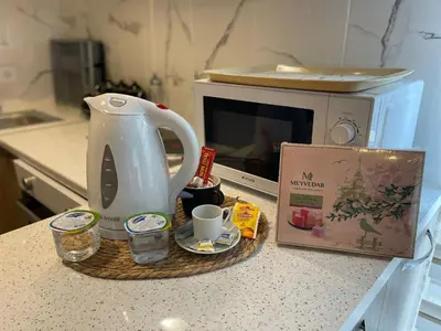 a kitchen counter with a tea kettle and a microwave at King Suite BH37 in Istanbul