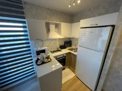 a kitchen with a white refrigerator and a sink at King Suite AN9 in Istanbul