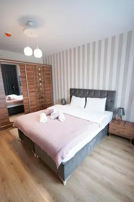 a bedroom with a large bed with two towels on it at King Suite AN9 in Istanbul