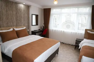 a hotel room with two beds and a window at HOTEL GLOBAL 2022 in Istanbul